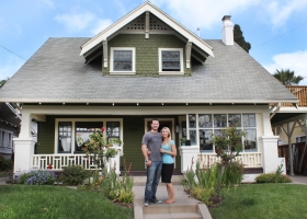 Couple standing in front of energy-efficienct home