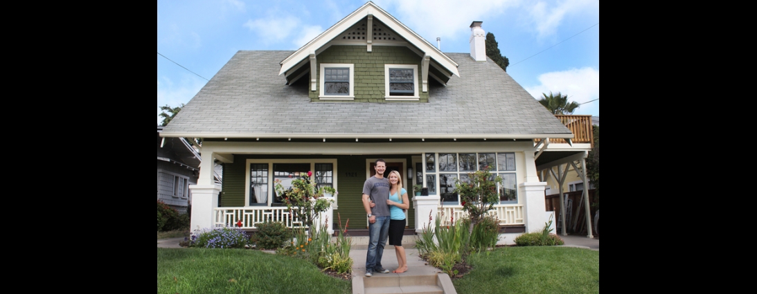 Couple standing in front of energy-efficienct home